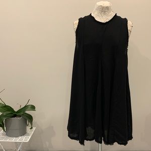 Black sleeveless tunic with raw edges and tie neck